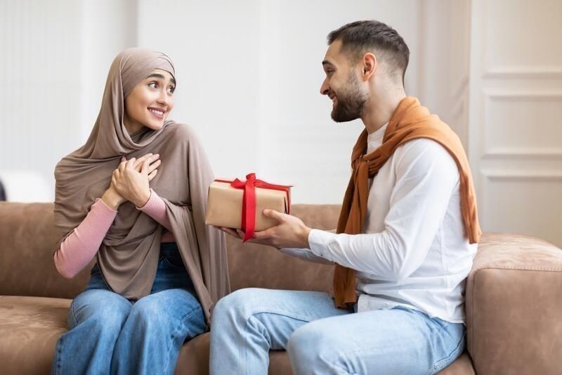 husband giving gift to wife